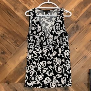 Sleeveless White House Black Market blouse. Black with white floral pattern.